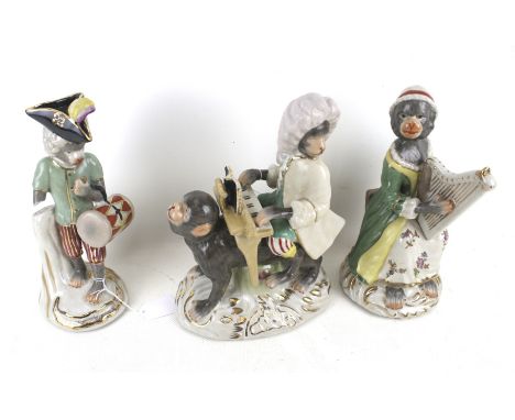 Three 20th ceramic figures modelled as monkey musicians. Comprising one playing a piano, drum and a harp, Max. H26cm 