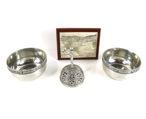 A silver plaque, a pair of silver-plated round bowls and a plated bell. Comprising; an Italian silver-mounted rectangular pla