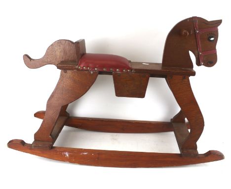 A vintage scratch built plywood rocking horse. With painted features and a red leather seat, H61cm