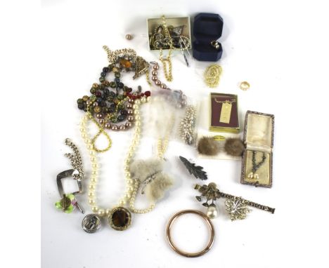 A collection of costume jewellery including a rolled-gold tubular slave bangle; an amethyst-coloured paste rectangular ring; 