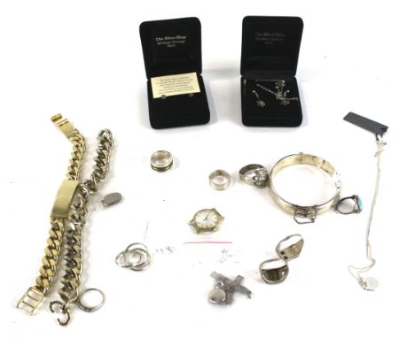 A collection of silver and other jewellery including seven rings. A part foliate engraved hollow hinged bangle; a Latin cross
