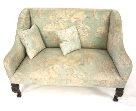 A 20th century sofa and two cushions. Upholstered in fabric printed with a map of the world, raised on carved cabriole suppor