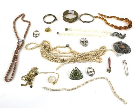 A collection of costume jewellery to include a base metal Egyptian winged mask bangle. Various brooches; buckles; a paste bi-