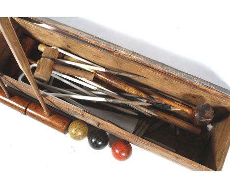 A boxed vintage croquet set. Comprising six metal hoops, three mallets and three balls, etc. 