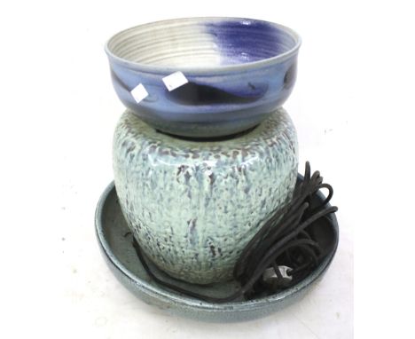 A garden stoneware water feature and a studio pottery bowl. The fountain designed as a blue glazed stand positioned atop a bl