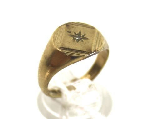 A vintage 9ct gold and diamond signet ring. The round head centred with a tiny eight-cut diamond within engraved lozenge bord