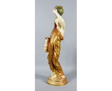 A Royal Worcester Porcelain "Blush Ivory" Standing Figure of a Grecian Water Carrier, balancing an urn on her head and carryi
