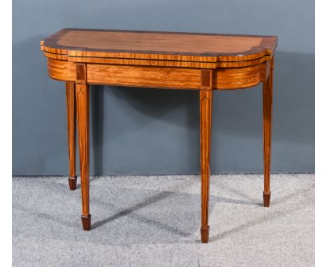 A George III Rosewood and Satinwood Card Table of shaped outline, the folding top with rosewood cross-banded edge, revealing 