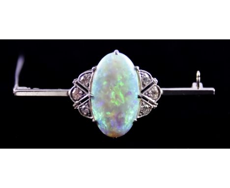 An Opal and Diamond Brooch, set with a centre opal stone, 20mm x 12mm, flanked with three small brilliant cut white diamonds,