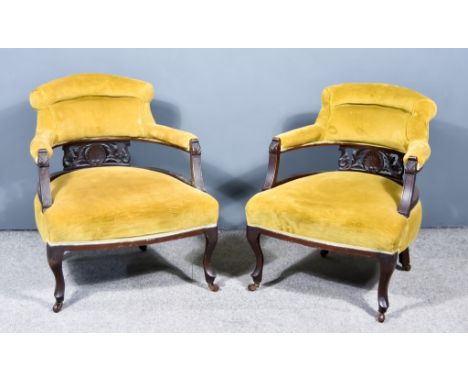 A Pair of Victorian Tub Shaped Armchairs, each with leaf and shell carved fretted splats, the back, seats and arms upholstere