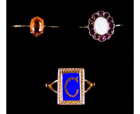Three 9ct Gold Rings, comprising - one with enamel letter C,size l,&nbsp; one set with opal and red stone, size R,&nbsp; anot