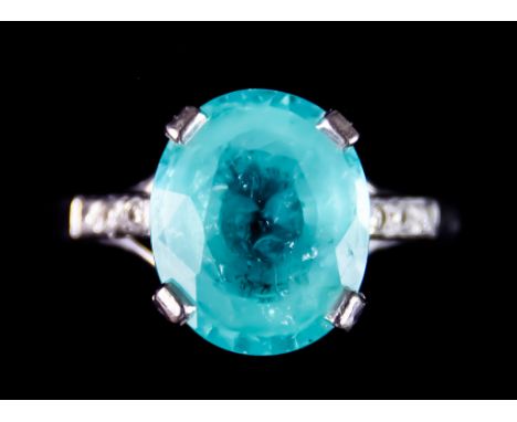 An 18ct White Gold Tourmaline and Diamond Ring, set with a centre paraiba tourmaline, approximately 7.5ct, flanked by small b