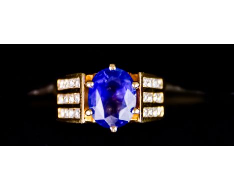 An 18ct Gold Sapphire and Diamond Ring, set with a centre faceted sapphire, approximately 4.7ct, flanked by small brilliant c