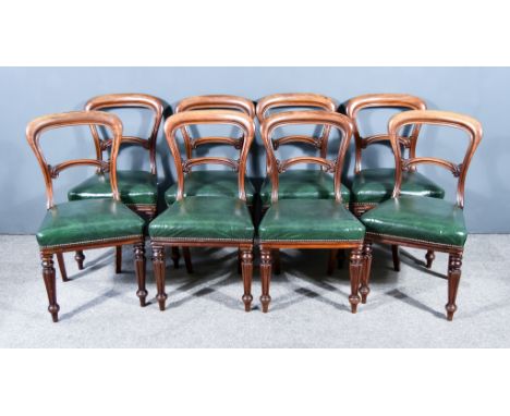 A Set of Eight William IV Mahogany Dining Chairs, each with plain curved crest rails, leaf carved splats, the seats upholster