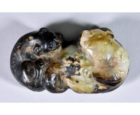 A Chinese Celadon and Brown Jade Carving of Two Lion Dogs, of Ming style but later, 2.5ins (6.4cm) wideThis appears to be in 