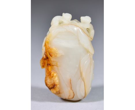 A Chinese White Jade with Russet Inclusions Snuff Bottle, 18th Century, carved as a fruit with leaves and two monkeys, 2.5ins