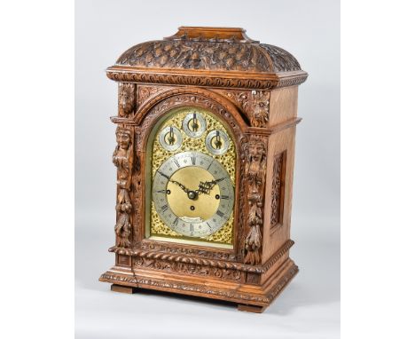 A 19th Century Oak Table Clock by J J Stockall &amp; Sons Ltd, London, the arched brass dial with matted dial centre, silvere