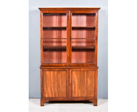 A 19th Century Mahogany Bookcase, the upper part with moulded cornice, fitted three shelves enclosed by a pair of glazed door