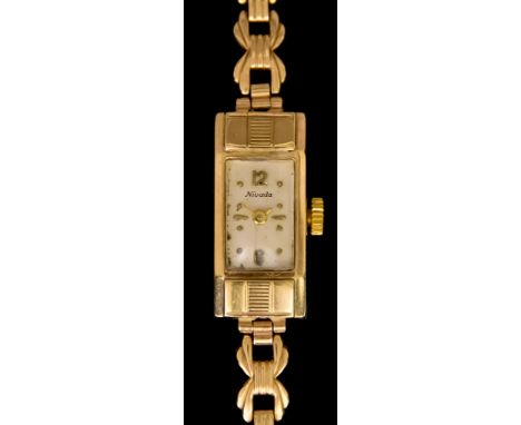 A Lady's&nbsp;9ct Gold&nbsp;Manual Wind Cocktail Wristwatch&nbsp;by Nivada, case, 24mm x 16mm, silvered dial with gold baton 