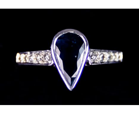 An 18ct White Gold Topaz and Diamond Ring, set with a centre tear drop topaz stone flanked by small white diamonds, size U, g