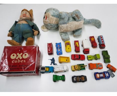 Chad Valley cat, snow white dwarf, and diecast toys in an Oxo tin