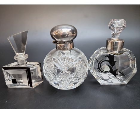 A silver mounted cut glass scent bottle; together with another silver mounted scent bottle; and an Art Deco cut glass scent b