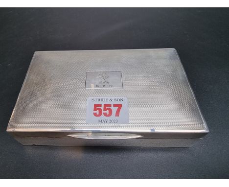 A silver engine turned cigarette box,&nbsp;by&nbsp;Padgett &amp; Braham Ltd, London 1929, 14cm long. 