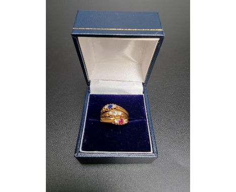 An 18ct gold three band ring, set ruby, sapphire and nine diamonds, hallmarked Chester 1902, size N, gross weight 4.4g. 