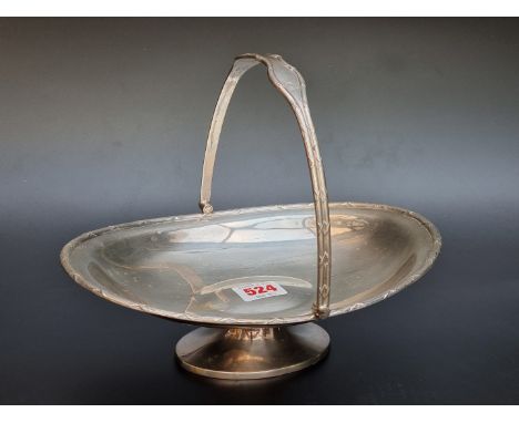 A silver swing handled pedestal basket, by James Deakin &amp; Sons, Sheffield 1932, 25cm long, 479g. 