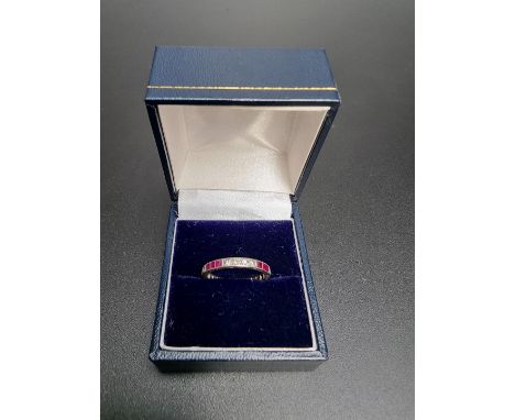 A ruby and diamond eternity ring, set fourteen single cut diamonds with an estimated total weight of 0.28ct and twelve square