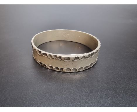 A Danish pewter bangle, by Jorgen Jensen, number 216, 7cm diameter. 