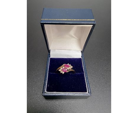 A yellow metal ruby and diamond ring, stamped 9ct, size R. 
