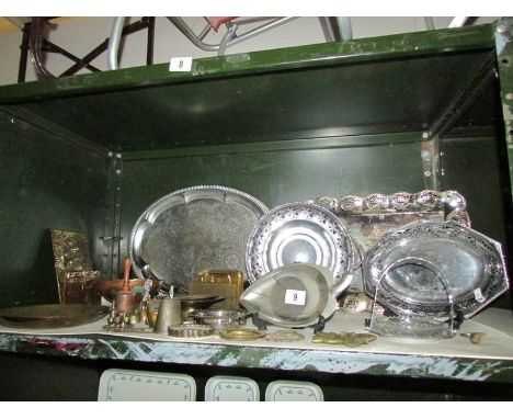 A shelf of assorted metal ware including trays.