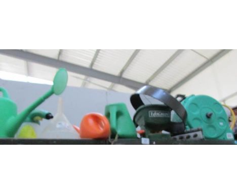 A mixed lot of garden items including watering can, hose pipe etc.,