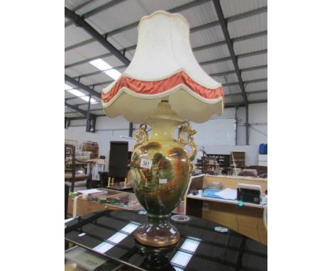 A pottery table lamp with shade.