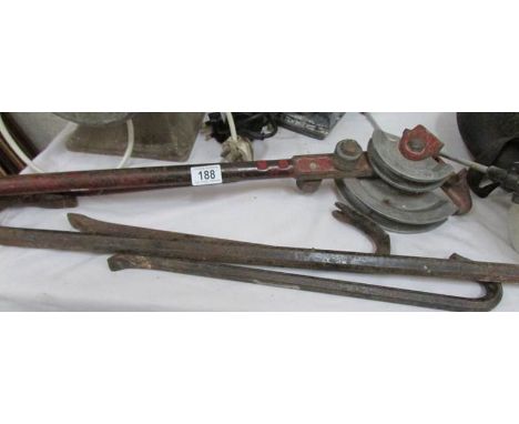 A pipe bender and 3 crow bars.