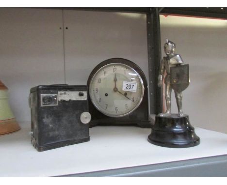 A Smith's mantel clock, a Kodak Brownie camera and a musical cigarette lighter in the form of a knight.