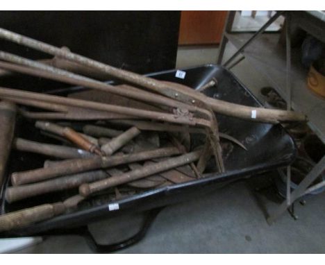 A wheel barrow and garden tools.