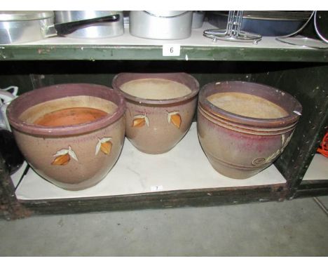 A shelf of ceramic planters.