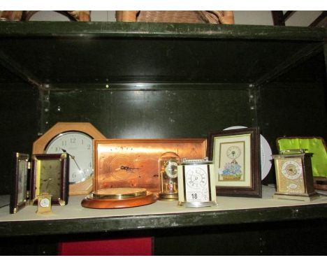 A shelf of assorted clocks.