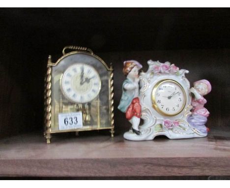 An anniversary clock (feathe damaged) and a ceramic figural clock.
