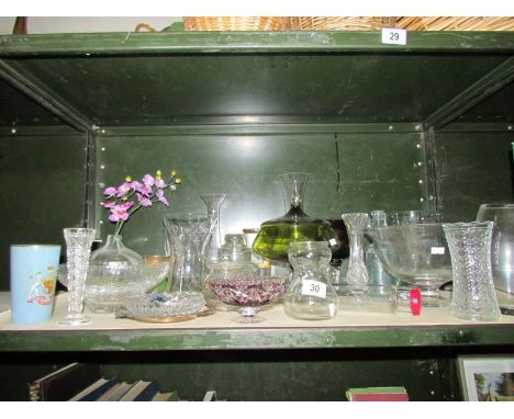 A shelf of assorted glass ware.