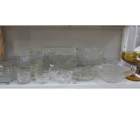 A shelf of assorted glass ware.