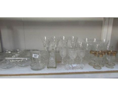 A shelf of assorted glass ware.