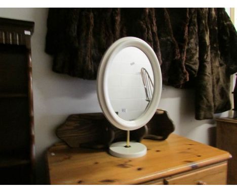 A white dressing table mirror and a wall shelf.