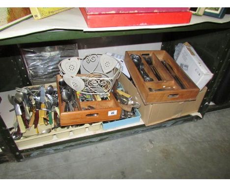 A shelf of assorted cutlery.