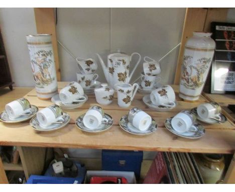 A coffee set, 6 coffee cans with saucers and 2 vases.