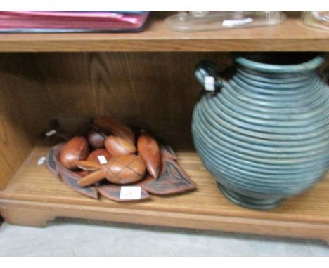 A shelf of wooden fruit, vase etc.,