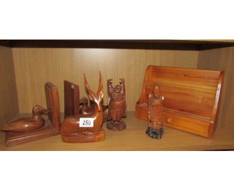 A shelf of wooden items including duck bookends, Buddha, letter rack etc.,