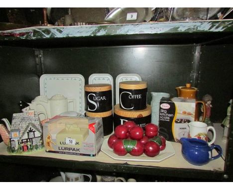 A shelf of miscellaneous including teapots, storage jars etc.